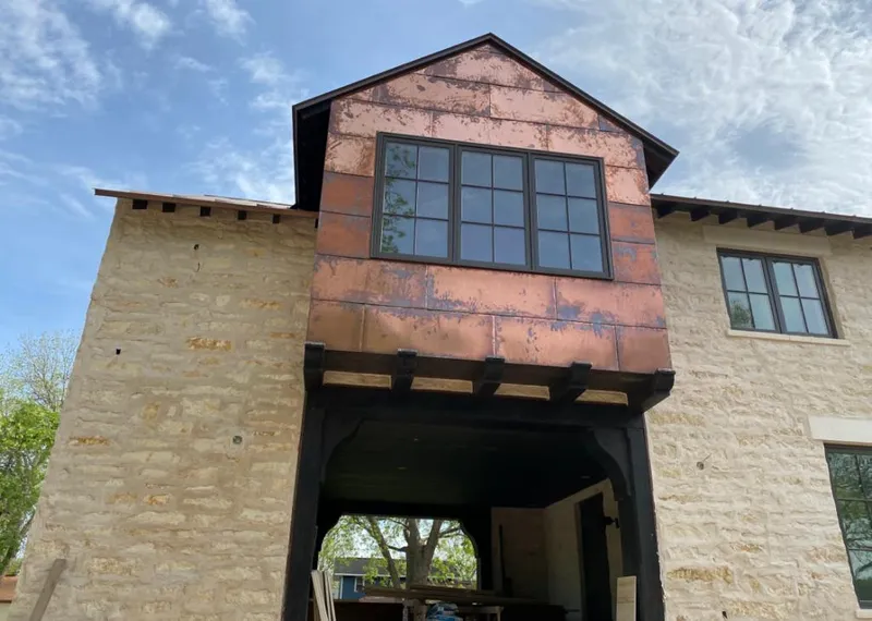 Copper metal panel facade on a stone building for Skylight Installation in Rockland